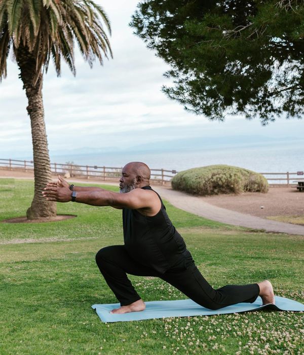 Man in a simple stretching pose on a yoga mat.