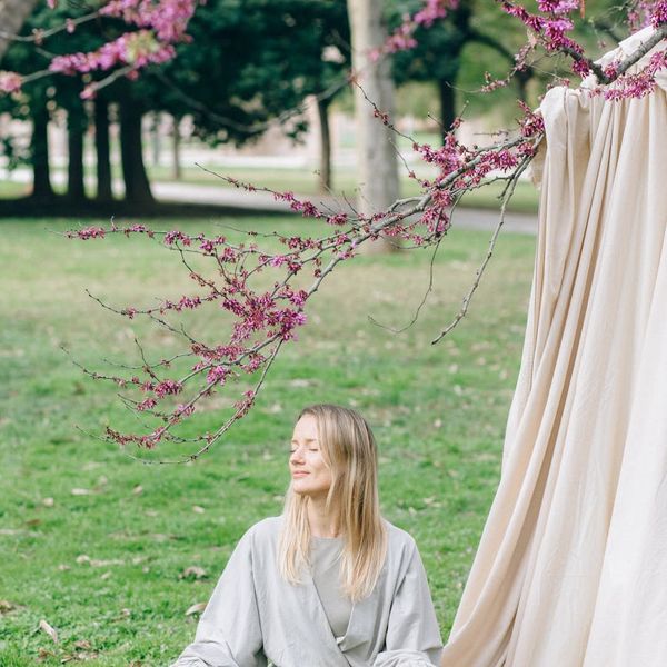 Woman meditating peacefully in a calm, serene environment.